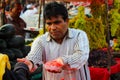 Fruit seller giving chopped watermelon and collecting cash Royalty Free Stock Photo