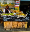 Fruit seller selling fruits in a small shop