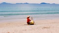Fruit seller in triangular straw hat On Vietnam Beach, Popular Tourist Destination, South Vietnam