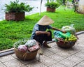 Fruit seller walks with a carrying pole in the old quarter. The 36 old streets Royalty Free Stock Photo