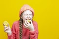 Fruit Series. Winsome Girl In Coral Knitted Clothing Biting Yellow Lemon Slices In Front of Face