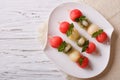 Fruit skewers of watermelon, kiwi and melon. Horizontal top view Royalty Free Stock Photo