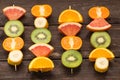 Fruit skewers on the wooden background Royalty Free Stock Photo