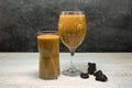 Fruit smoothie in a glass on a table decorated with prunes. Side view. Royalty Free Stock Photo
