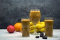 Fruit smoothie in glasses, with fruits on the table. Royalty Free Stock Photo