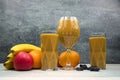 Fruit smoothie in glasses, with fruits on the table. Royalty Free Stock Photo