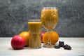 Fruit smoothie in glasses, with fruits on the table. Royalty Free Stock Photo