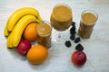 Fruit smoothie in glasses, with fruits on the table Royalty Free Stock Photo