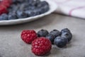 Fruit smoothies with blueberries, raspberries, apple, orange , pear and banana on gray background.