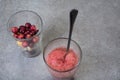 Fruit smoothies with blueberries, raspberries, apple, orange , pear and banana on gray background.