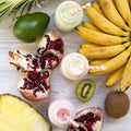 Fruit smoothies or milkshakes of different tastes in glass bottles with ingredients on white wooden surface, top view. Flat lay. Royalty Free Stock Photo