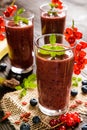 Fruit smoothies with red currants, blueberry, banana, goji berries and chia seeds Royalty Free Stock Photo