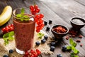 Fruit smoothies with red currants, blueberry, banana, goji berries and chia seeds Royalty Free Stock Photo