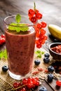 Fruit smoothies with red currants, blueberry, banana, goji berries and chia seeds Royalty Free Stock Photo