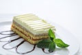 Fruit sponge cake with topping and mint leaf on white plate, product photography for shop or patisserie Royalty Free Stock Photo