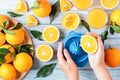 Fruit squeezer and ripe fresh oranges on blue wooden table top, fresh orange juice making, top view Royalty Free Stock Photo
