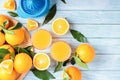 Fruit squeezer and ripe fresh oranges on blue wooden table top  fresh orange juice making  top view Royalty Free Stock Photo