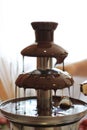 Fruit on a stick under the dripping chocolate in a chocolate fountain Royalty Free Stock Photo