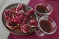 Fruit still life with open pomegranate and glass wine glasses with pomegranate juice