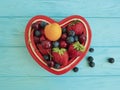 fruit strawberry, blueberry, cherry, apricot detox plate heart on blue wooden Royalty Free Stock Photo