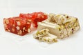 Fruit sweets and halva with nuts on white background.