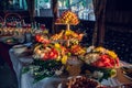 Fruit table with Canape appetizer: carved watermelons filled with pieces of melon and watermelon pulp, decorated with fresh