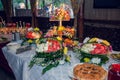 Fruit table with Canape appetizer: carved watermelons filled with pieces of melon and watermelon pulp, decorated with fresh