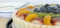 Fruit tart with fork and plates Royalty Free Stock Photo