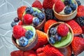 Fruit tarts on top of mixed berry background that includes red strawberries Royalty Free Stock Photo