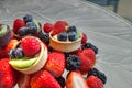 Fruit tarts on top of mixed berry background that includes red strawberries Royalty Free Stock Photo