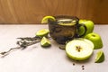 Fruit tea concept. Fresh lime and apple, dry herbs. Glass brown cup