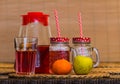 Fruit tea in glass with drinking straw, orange and apple on desk Royalty Free Stock Photo