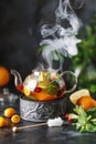 Fruit tea with mint, oranges and cranberry on dark stone background. A cup of hot tea Royalty Free Stock Photo