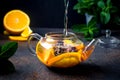Fruit Tea with orange and lemon Slice, berry, Mint and Honey in teapot Royalty Free Stock Photo
