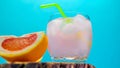 Fruit tropical alcoholic drink, cocktail on a bright colorful background with a slice of grapefruit. Alcoholic drink in a glass Royalty Free Stock Photo