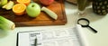 Fruit and vegetable on chopping board with Nutrition Facts on table. Royalty Free Stock Photo