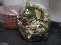 Fruit and vegetable peels scraps in plastic bag in a garbage plastic bin