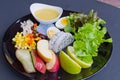 Fruit and vegetable salad on black plate Royalty Free Stock Photo