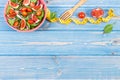 Fruit and vegetable salad, fork with tape measure, slimming and nutrition concept, copy space for text on boards Royalty Free Stock Photo