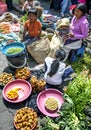 A fruit and vegetable seller with her children at the Indian market in Otavalo in Ecuador.