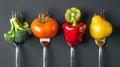 Fruit and vegetable on silver forks against a grey background concept for healthy eating, dieting, and antioxidants
