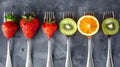 Fruit and vegetable on silver forks against a grey background concept for healthy eating, dieting, and antioxidants