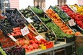Fruit and vegetable stand with basket full of seasonal fruits in Royalty Free Stock Photo