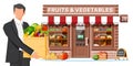 Fruit and vegetable store facade with man Royalty Free Stock Photo