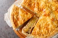 Fruit and vegetable Swiss cholera pie with apple, potato, pear, onion and cheese close-up on a wooden board. Horizontal top view