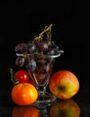 Grapes in ice coupe surrounded by other fruits