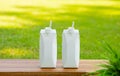 Fruit and vegetables drink concepts with set of assortment bottle on wood table in garden morning background.body refreshment