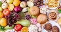 Fruit and vegetables vs sweets and fast food top view flat lay on orange background