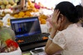 fruit vendor checking stock price