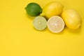 Fruit with vitamin C chopped and lie on a yellow background, lime and lemons